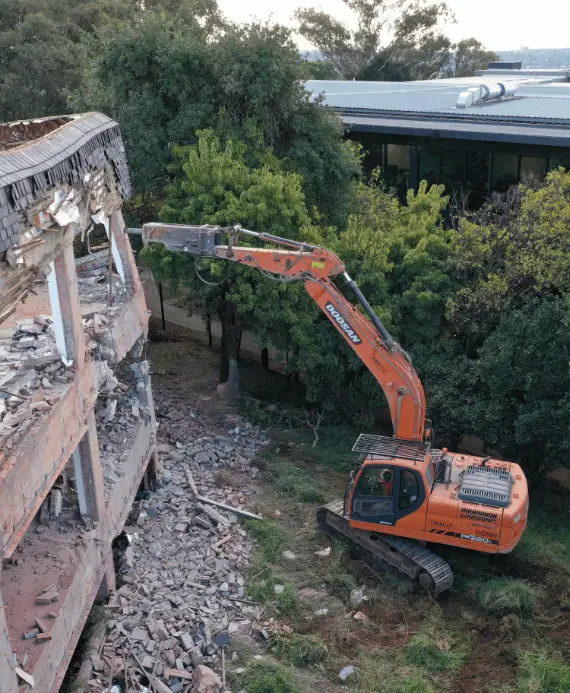 An excavator demolishing building 