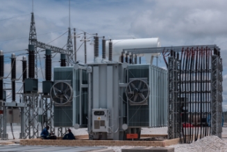 substation transformer with clouds in the sky